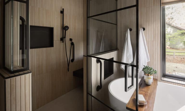 Modern bathroom with vertical-slat walls, black shower enclosure, tub, and window.)
