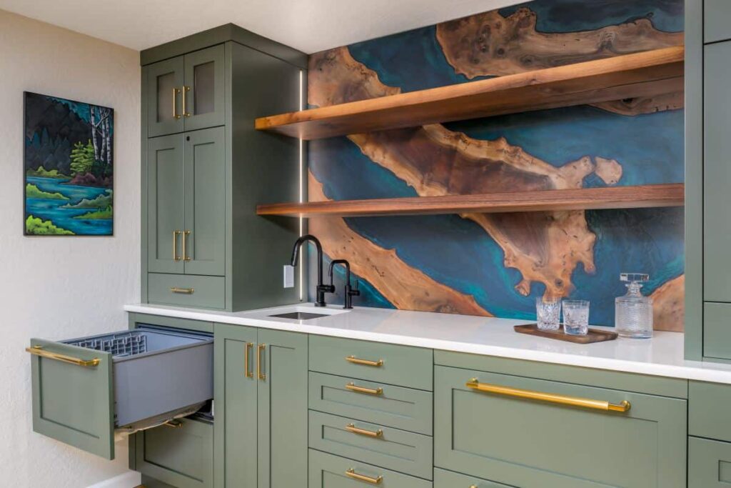 A wet bar with green cabinets and a small drawer dishwasher