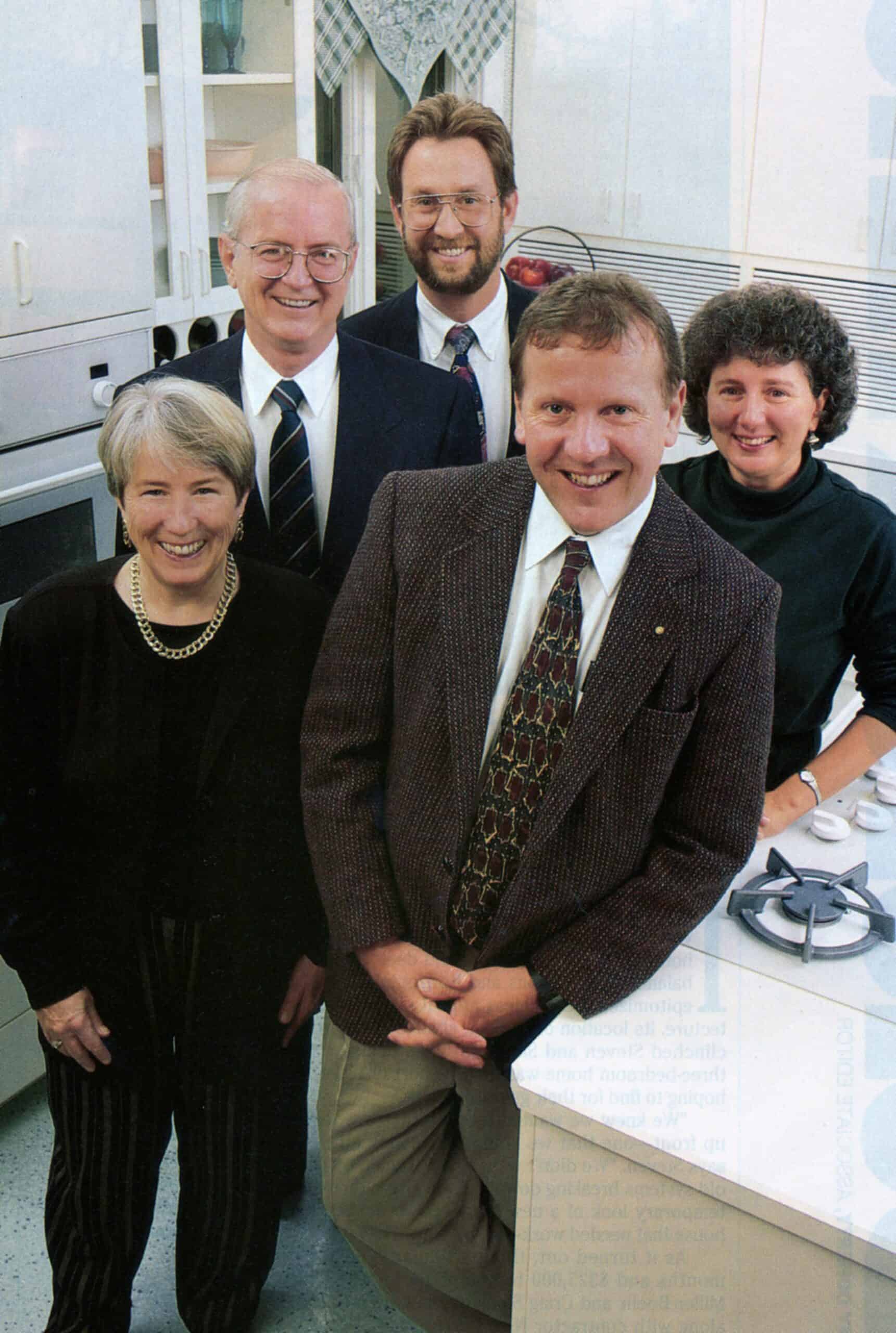 Martha Kerr stands with Tom Kelly and Company Leadership