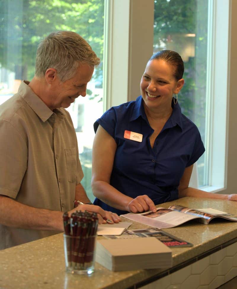 An interior designer consults with a homeowner at Neil Kelly