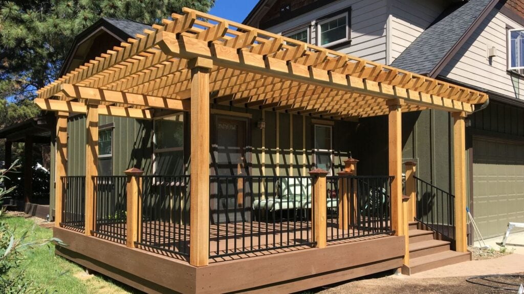 Cedar pergola over a composite deck with black metal railing at a Bend, Oregon home