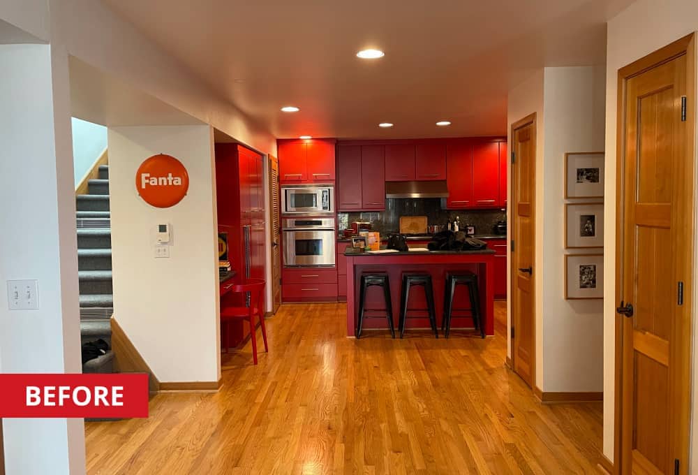 Slabtown District townhome kitchen with red paneled cabinets, dark granite countertops, and stainless steel appliances.