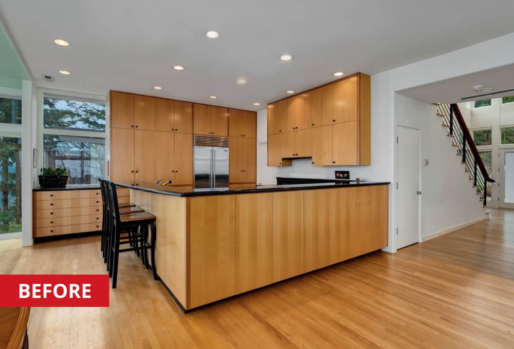 Kitchen counter around a kitchen space with black bar stools.
