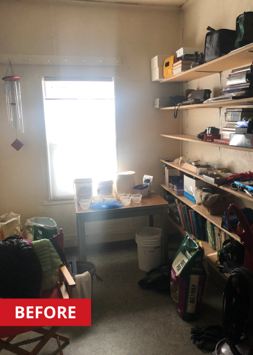 Work table and floating shelves in the corner of a garage.