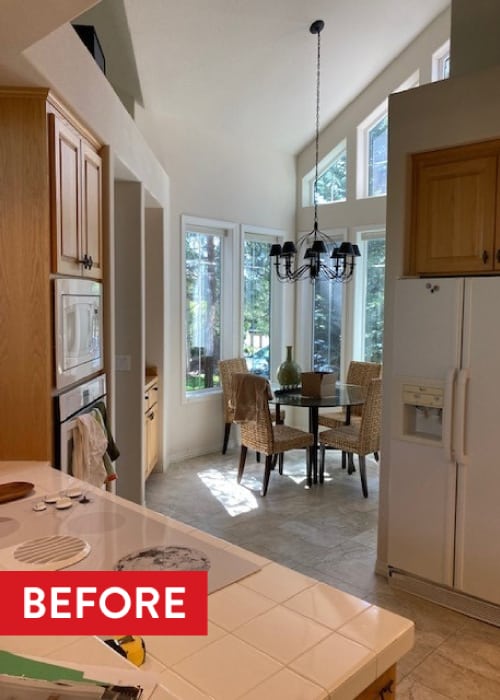 Kitchen countertop with white tile and an electric stovetop.