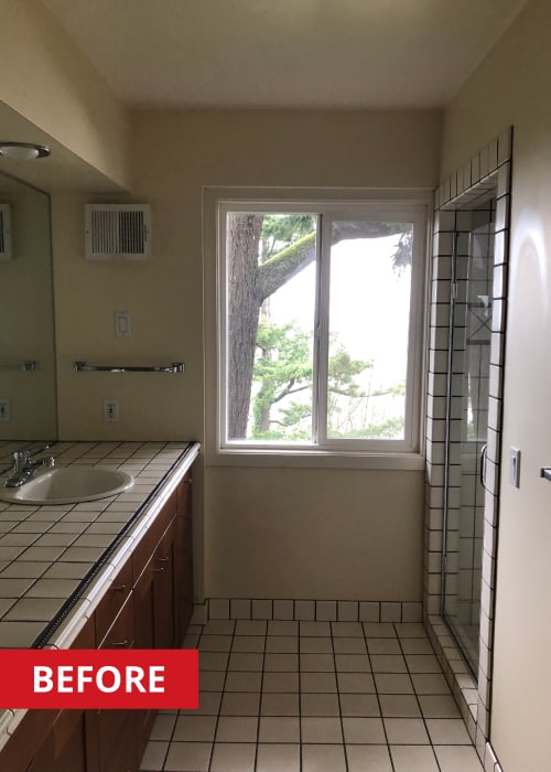 Old bathroom with a double vanity and walk-in shower.