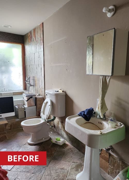Half-bathroom with window, mirror, sink, and toilet.