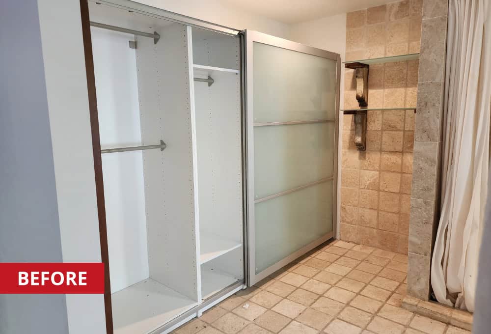 Walk-in shower with stone tile surround.