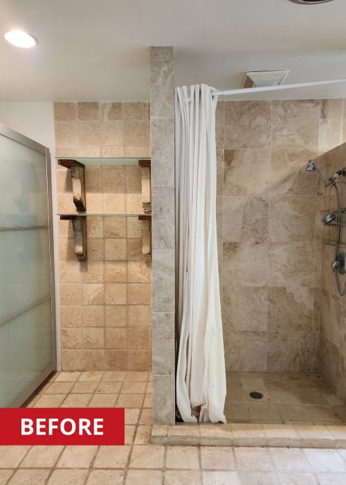 Walk-in shower with stone tile surround.