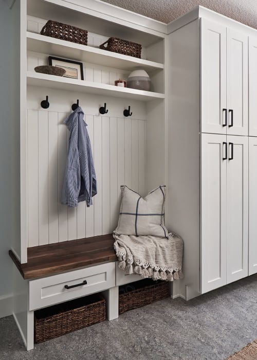 Entryway bench and storage with coat hooks and shelves.