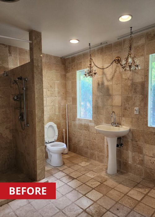 Walk-in shower with stone tile surround.