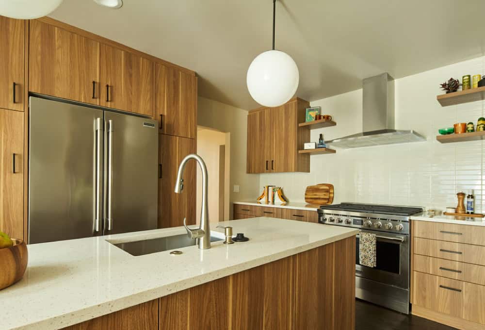 Kitchen with pendant lighting, wood cabinets, and hardwood floor.