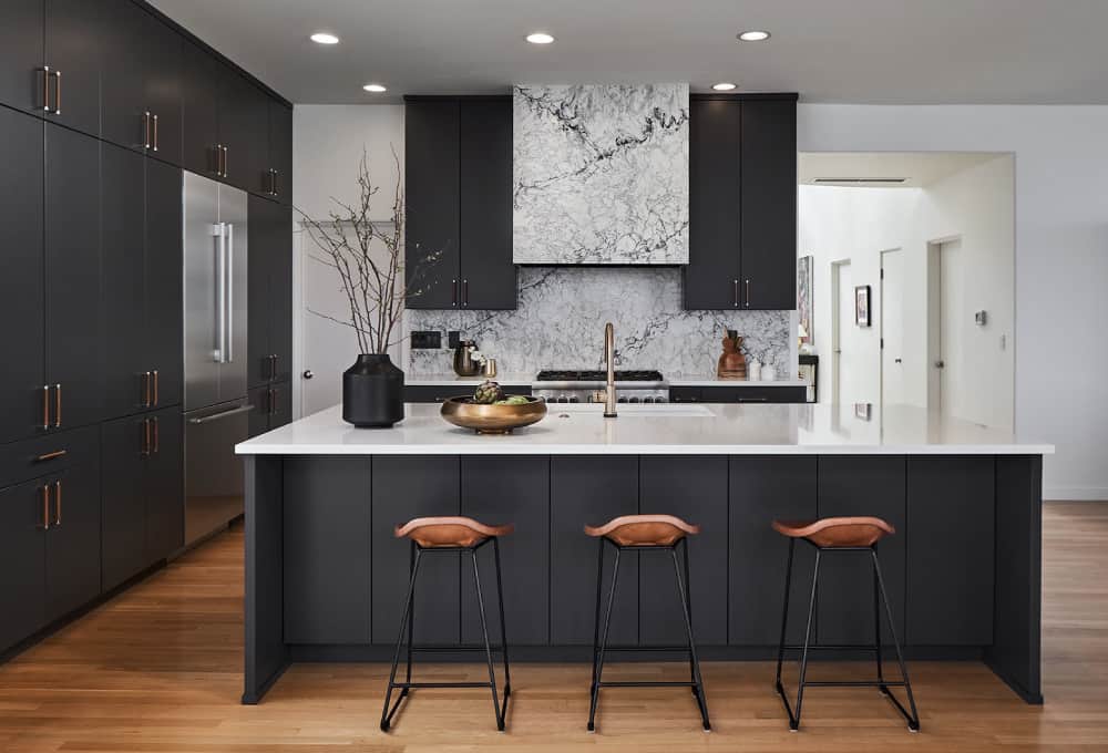 Modern kitchen bar with PentalQuartz kitchen counters and three bar stools.