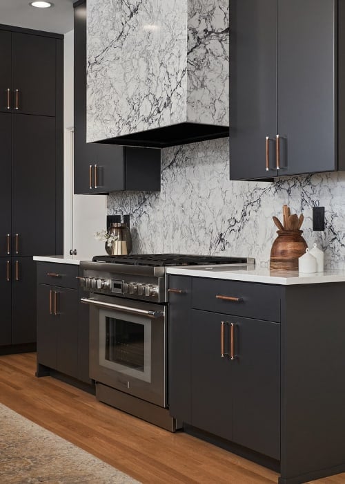 PentalQuartz kitchen counters, backsplash, and matching range hood that extends to the ceiling.