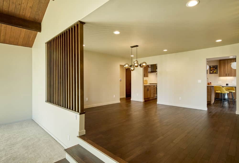 Large living room in mid-century modern house with wood floor.
