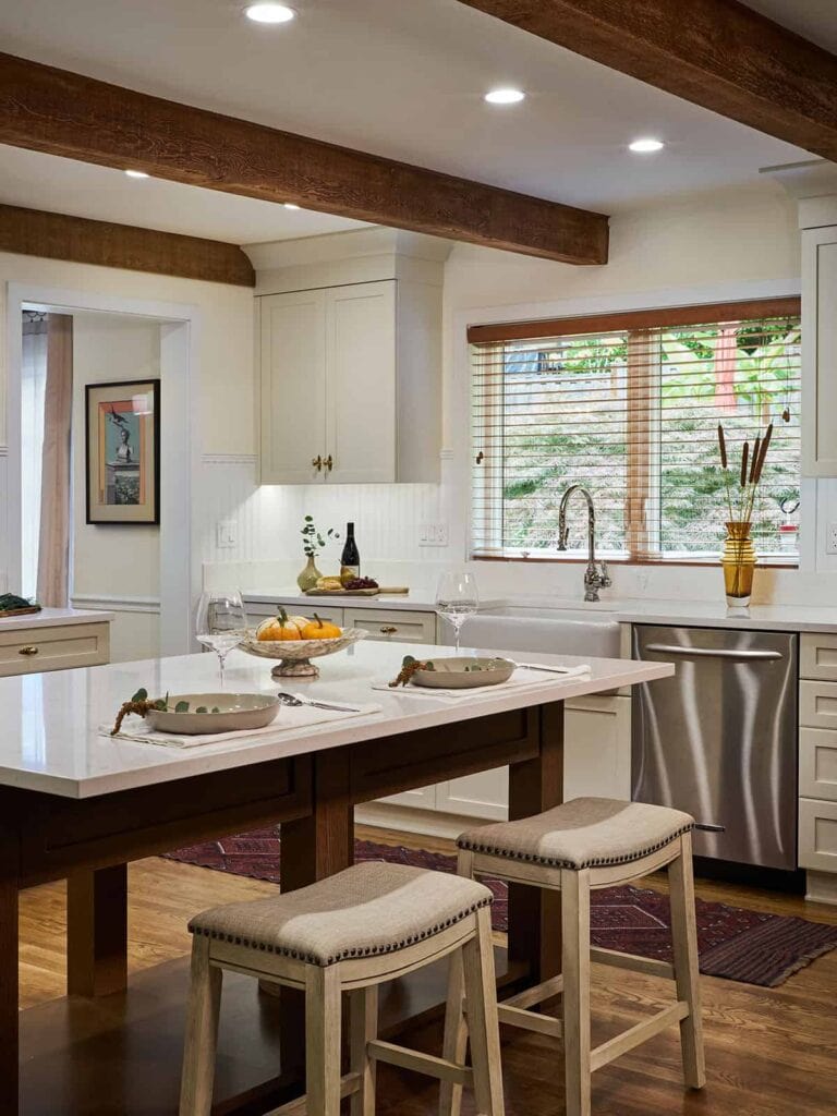 New England inspired kitchen remodel with natural light coming in through a nearby window.