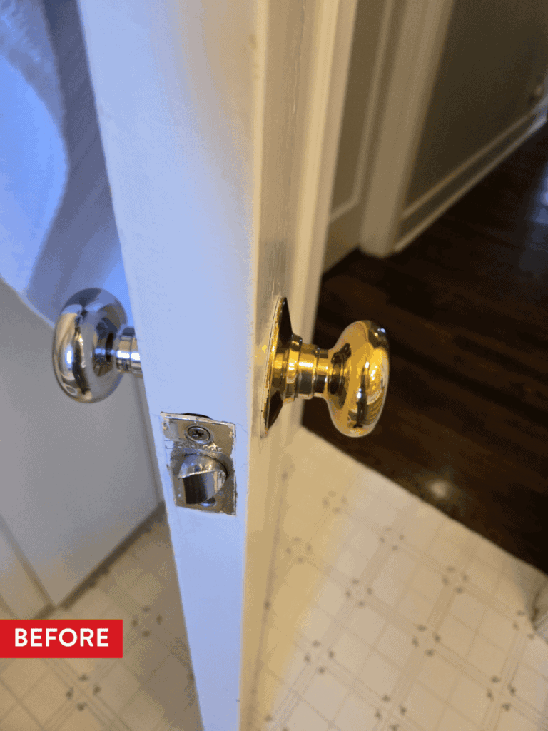 A bathroom door with different colored doorknobs