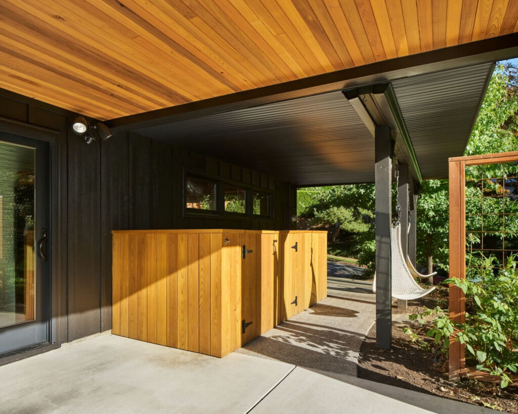 Covered walkway with cedar ceiling and a cedar storage enclosure with strap hinges.