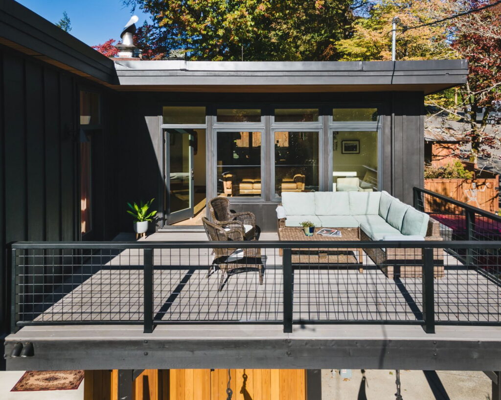 The deck seen head-on from the garden, with welded-wire railing infill and composite decking.