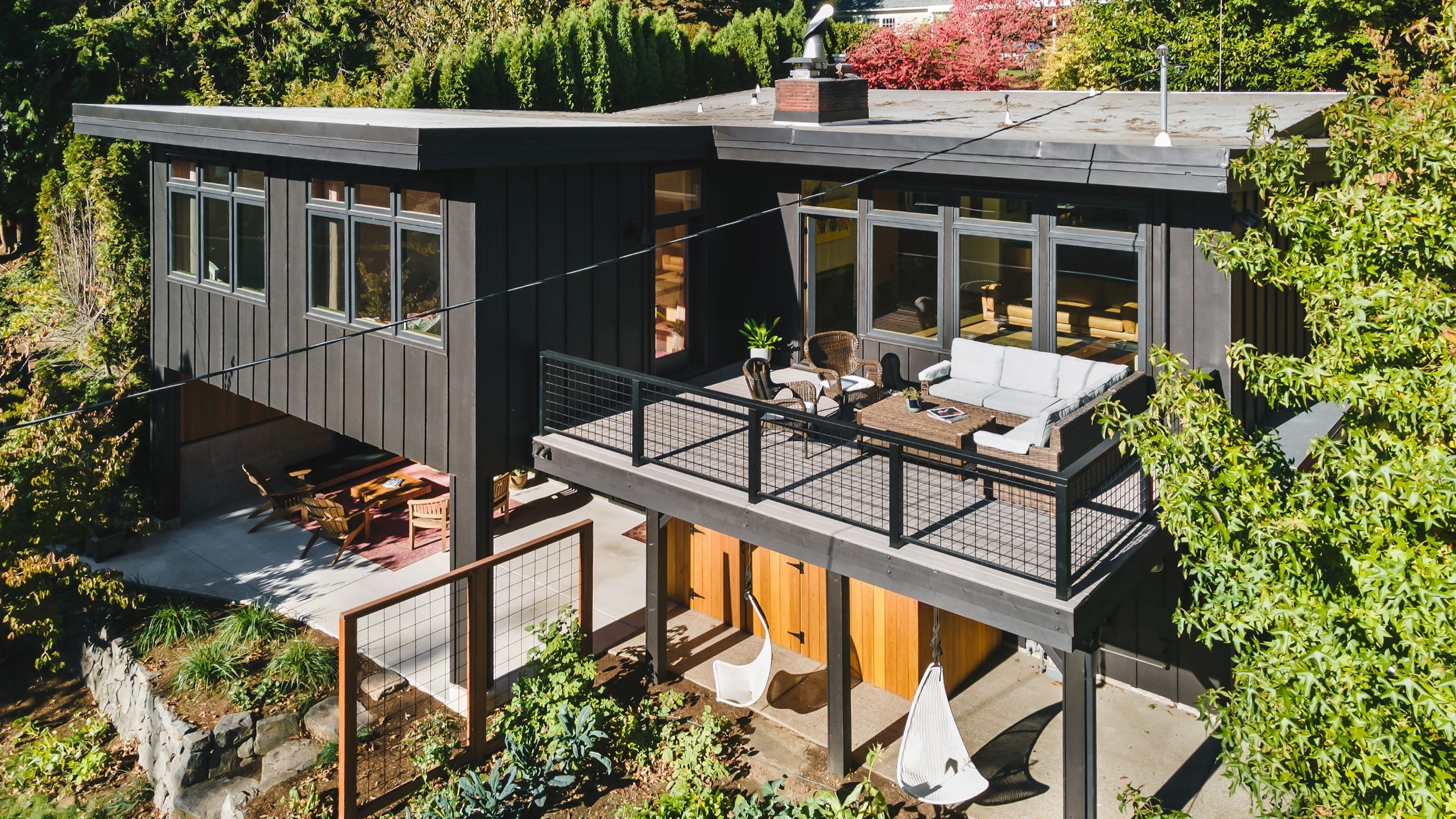 Elevated view of the addition, showing the upper deck and the covered patio and carport tucked beneath it.