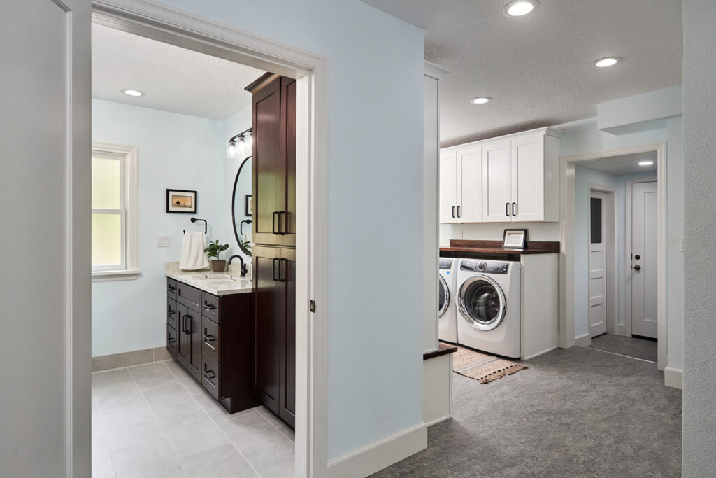 A functional laundry room-bathroom hybrid inside of a garage.