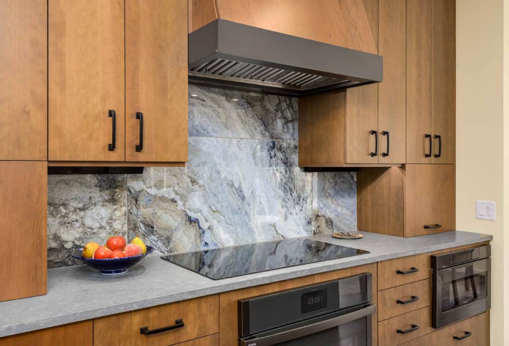 Induction cooktop with a dark gray accent strip on oven hood.