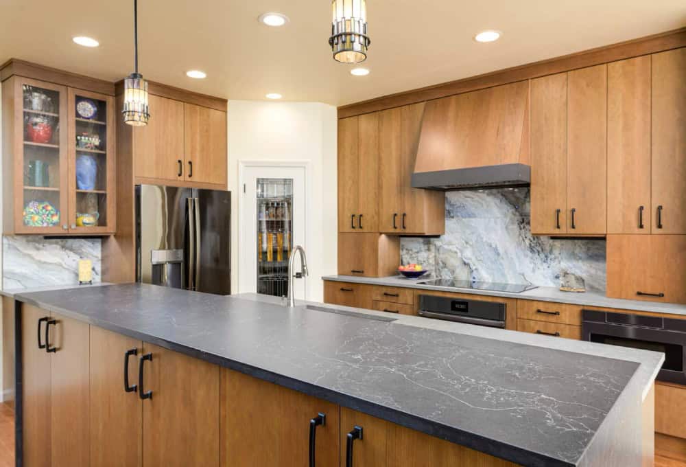 Induction cooktop with a dark gray accent strip on oven hood.