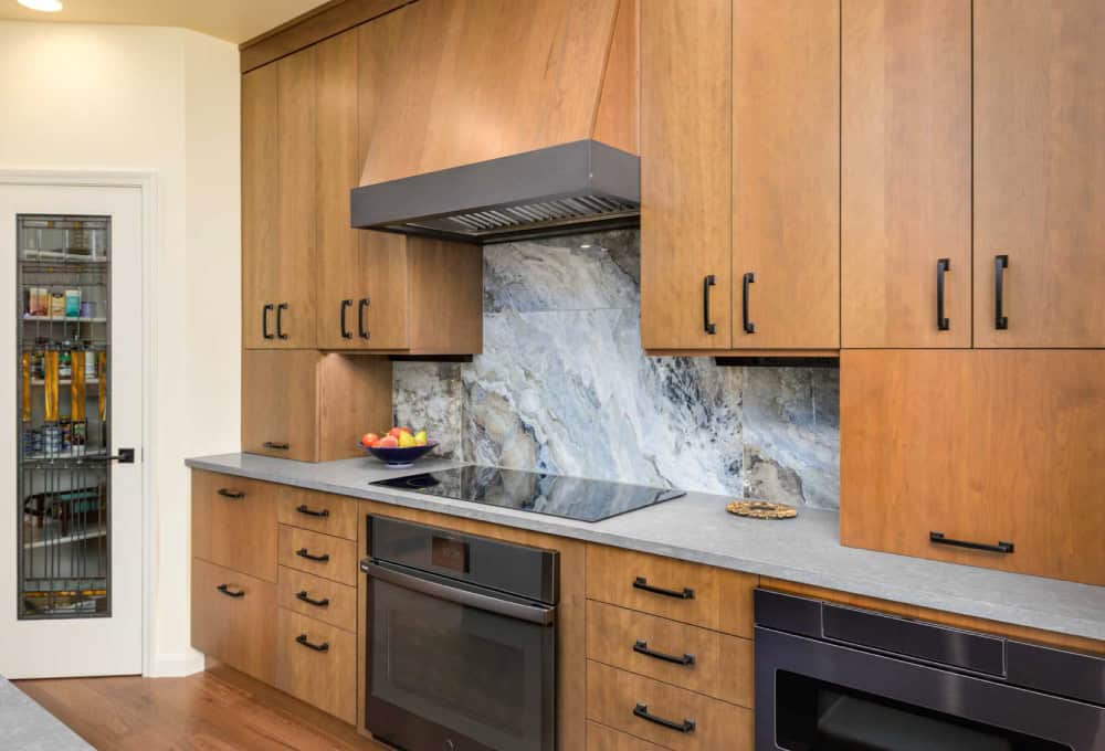 Induction cooktop with a dark gray accent strip on oven hood.