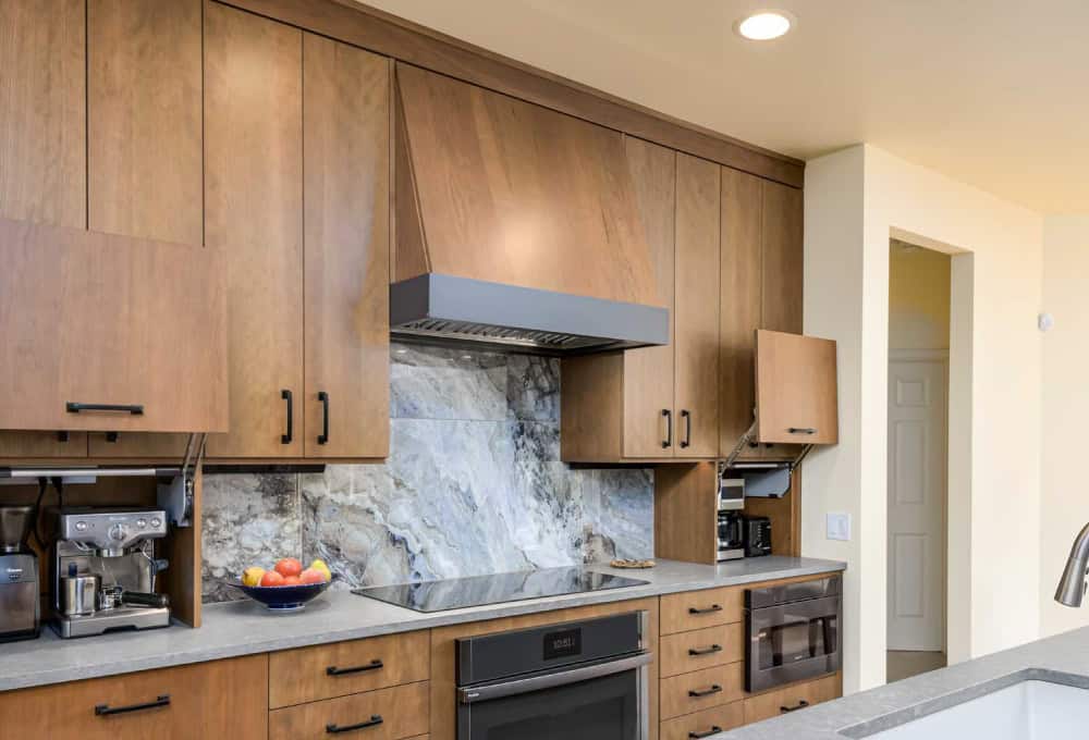 Induction cooktop with a dark gray accent strip on oven hood.