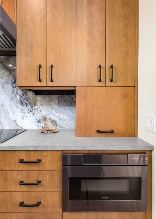 Walnut slab door cabinets from Decor Cabinets.