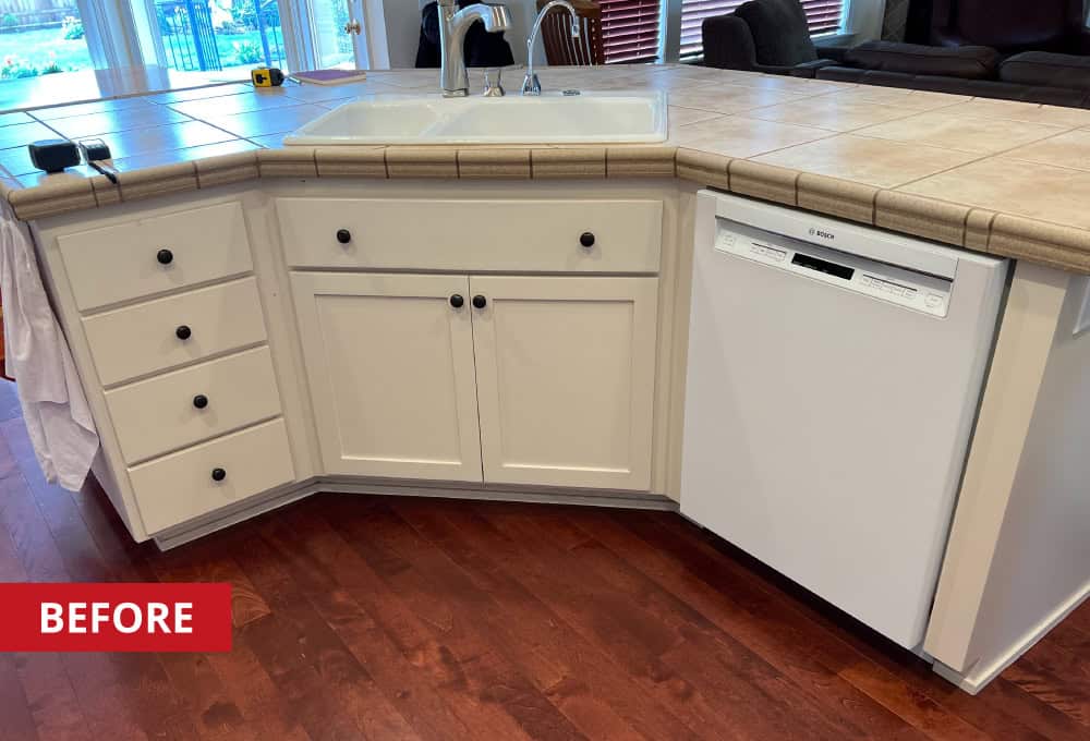 Kitchen island with a double basin sink in the middle.