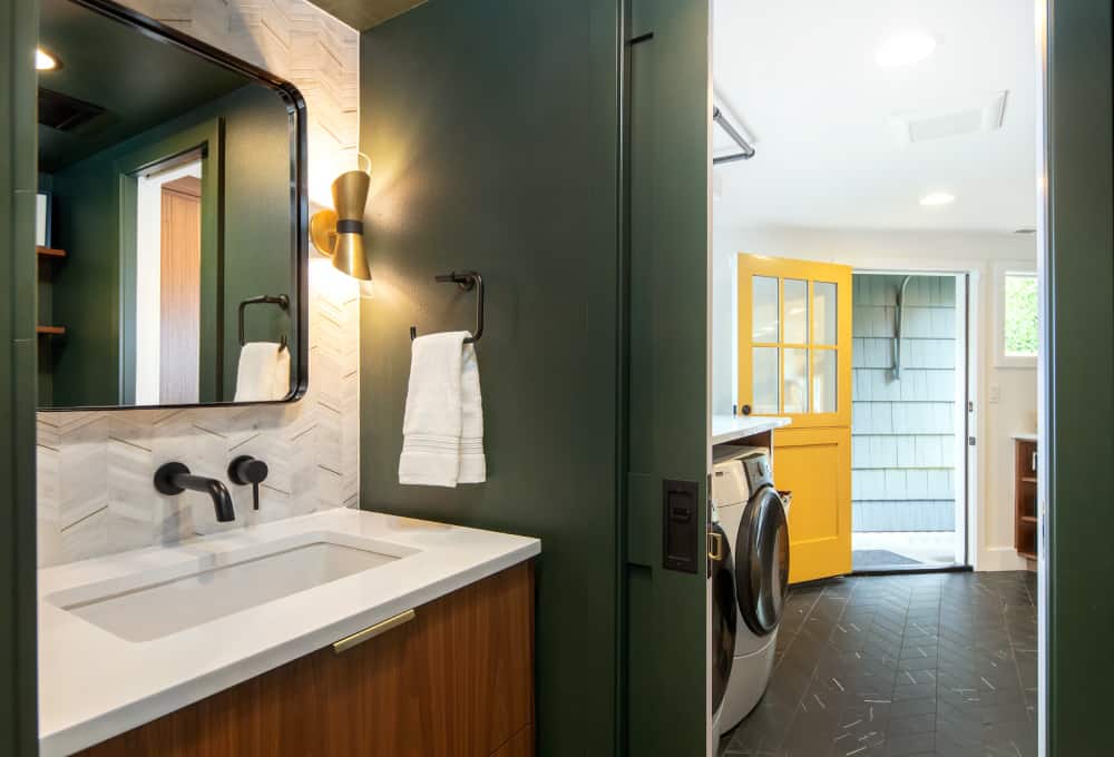 Bathroom sink with a white countertop and a black faucet.