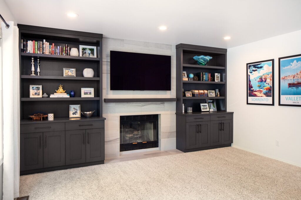Living room built-ins flanking the tile-faced fireplace, finished to match the kitchen cabinetry.