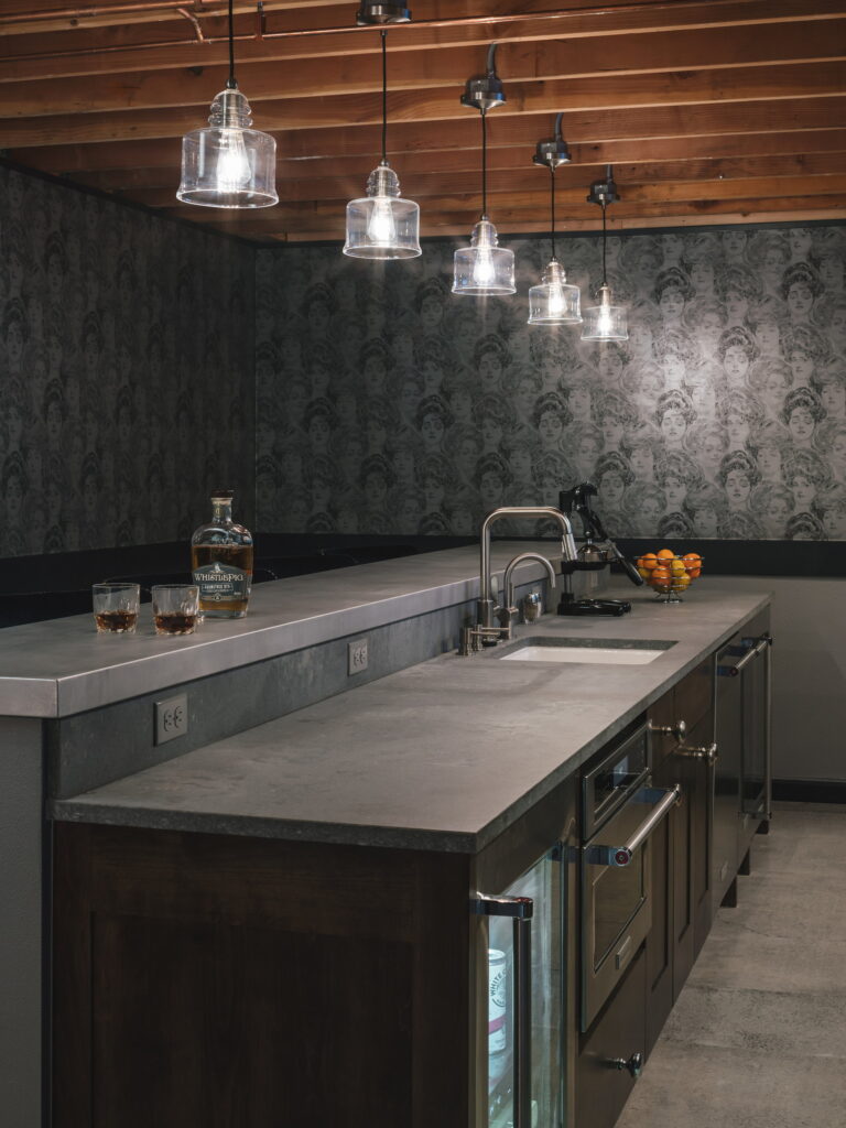 Bar island with an integrated sink, citrus press, and undercounter refrigeration.