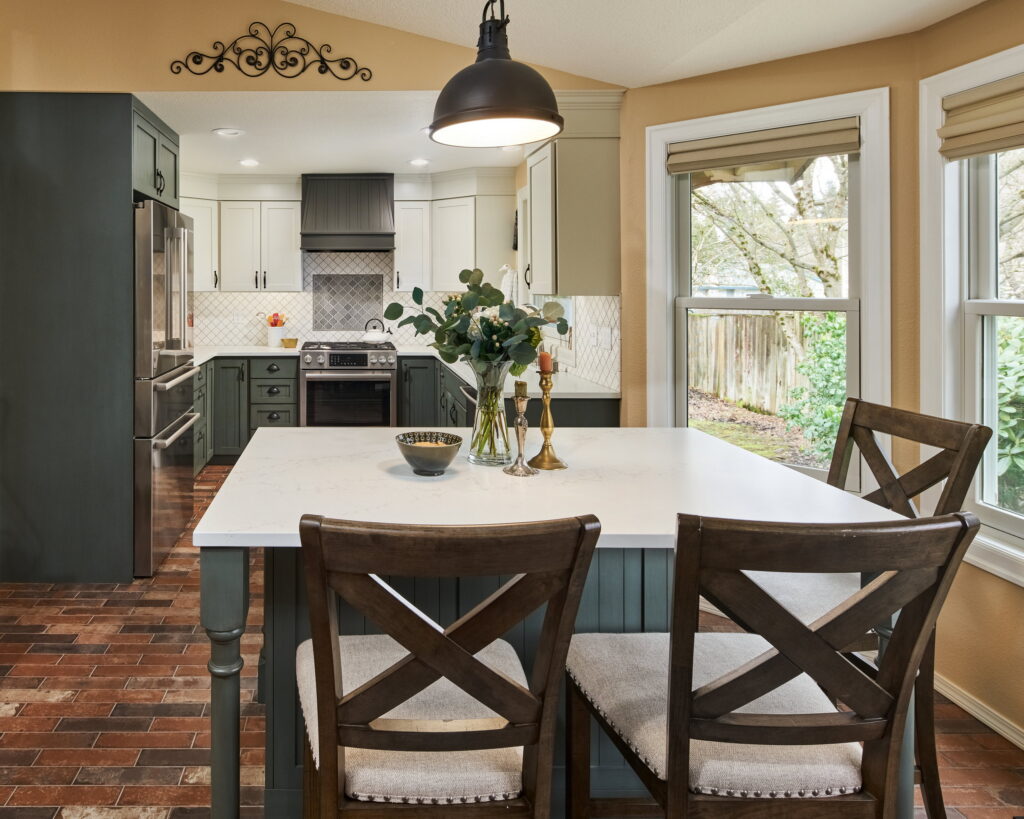 Island seating beneath a dome pendant, with the range wall and corner sink beyond.