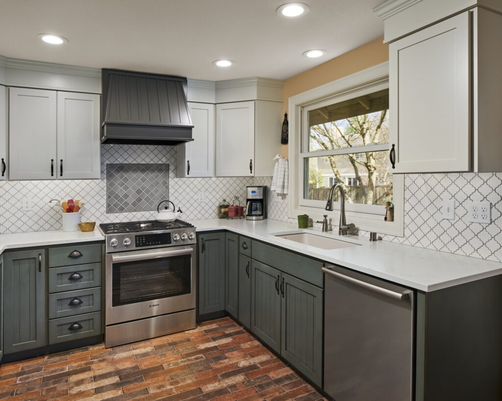 The working run of the kitchen, from the refrigerator past the range to the corner sink.