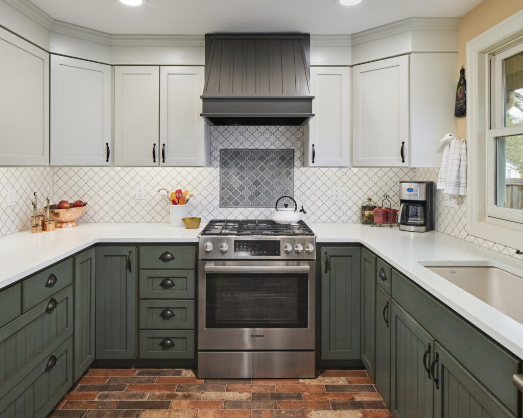 Range wall with a beadboard hood, gray lantern-tile accent panel, and a stainless gas range.