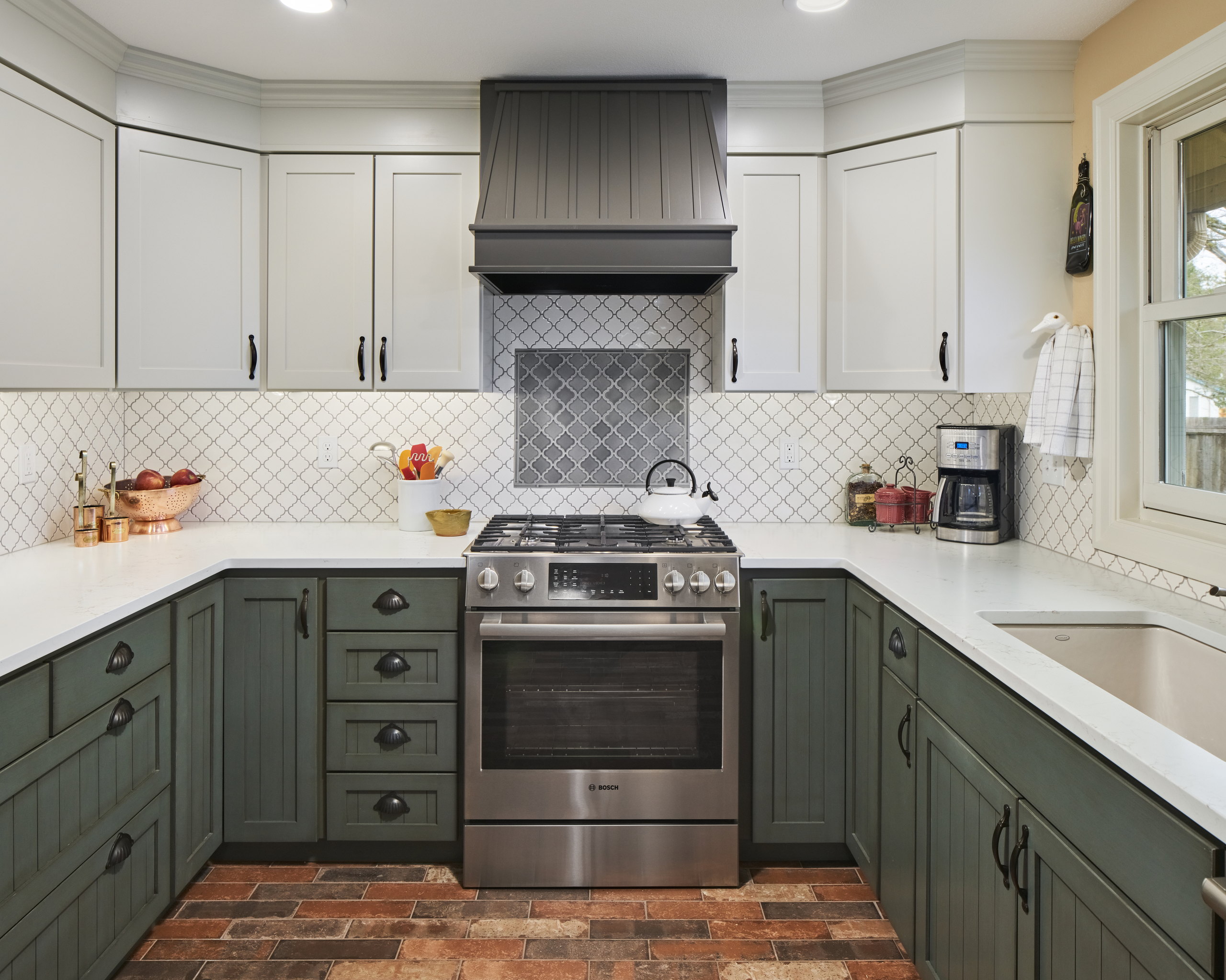 Range wall with a beadboard hood, gray lantern-tile accent panel, and a stainless gas range.