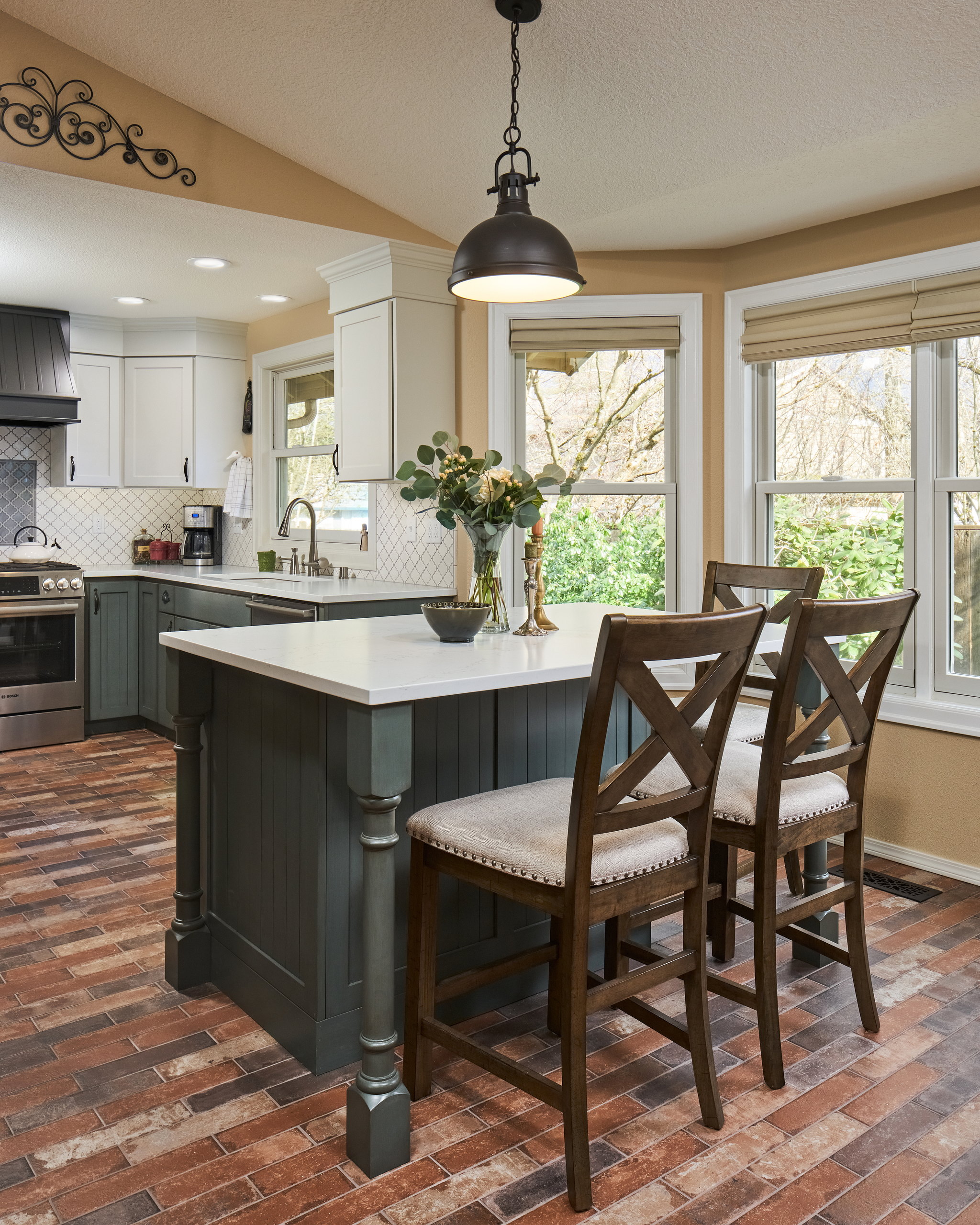 Range wall with a beadboard hood, gray lantern-tile accent panel, and a stainless gas range.