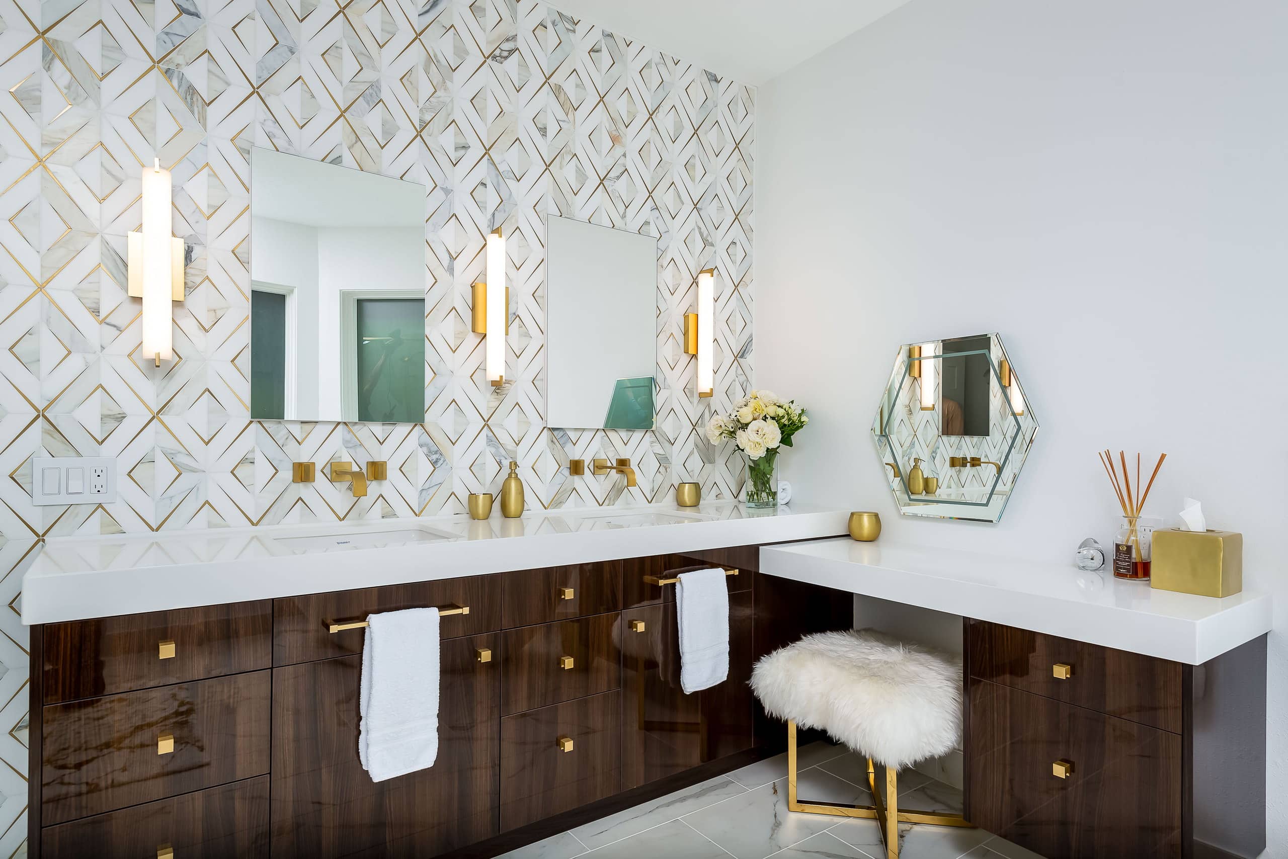 Remodeled West Eugene spa bathroom with a marble-and-brass inlay tile wall, high-gloss walnut double vanity, and a corner makeup table.
