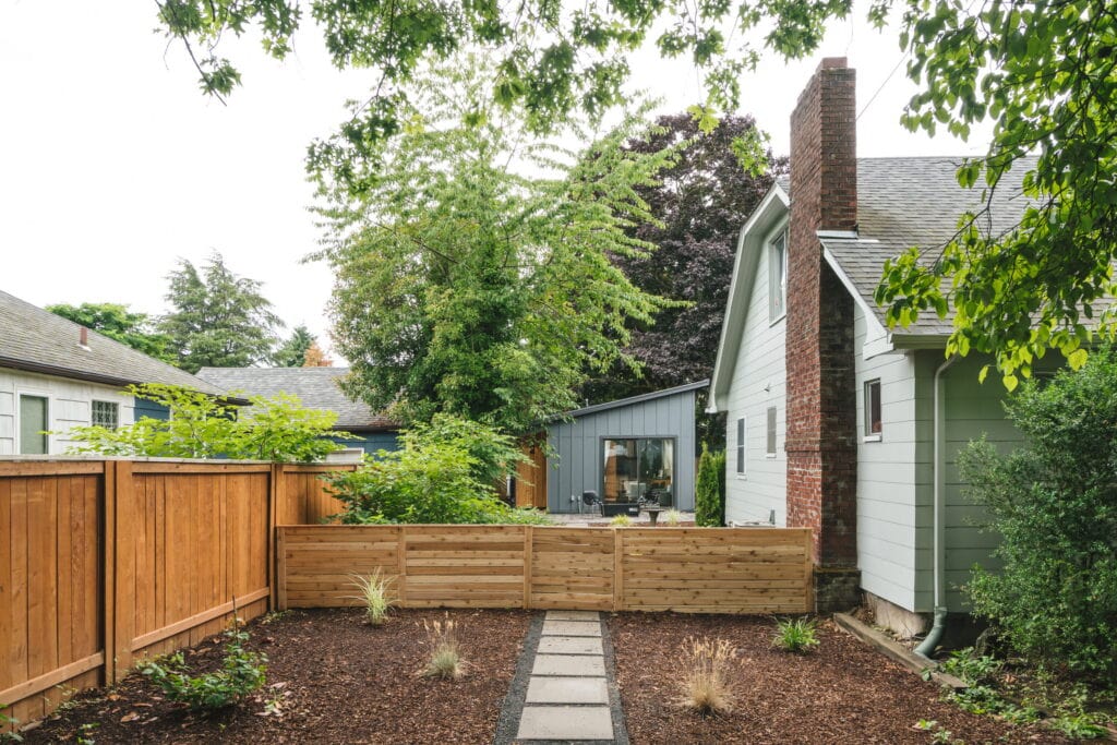 The backyard site, showing the ADU tucked behind the main house along the shared lot line.
