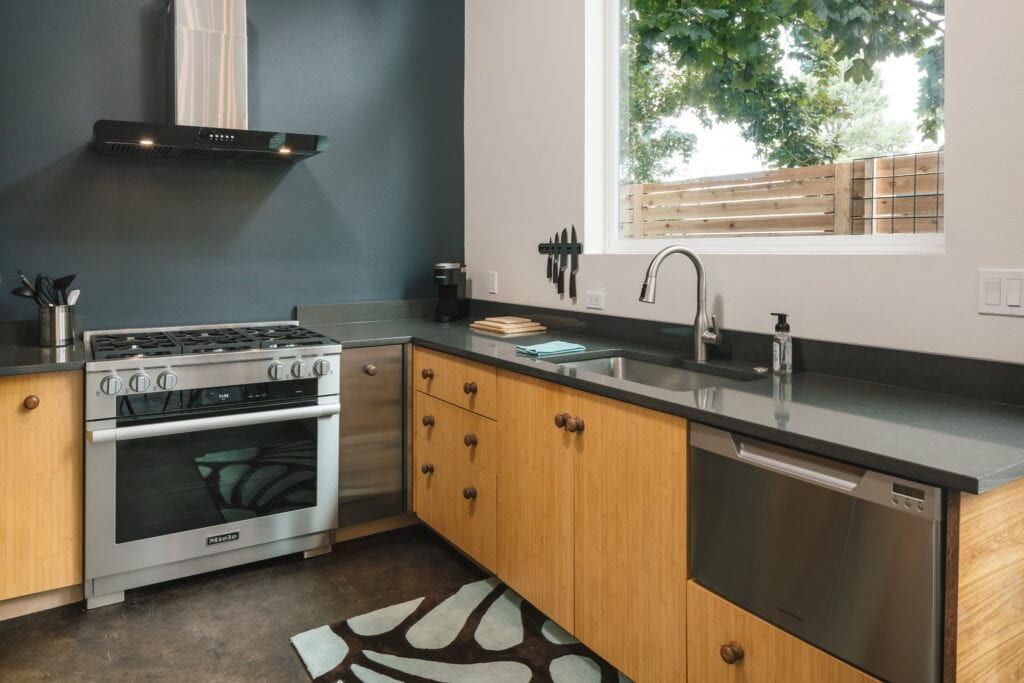 Kitchen with gas range and corner sink.