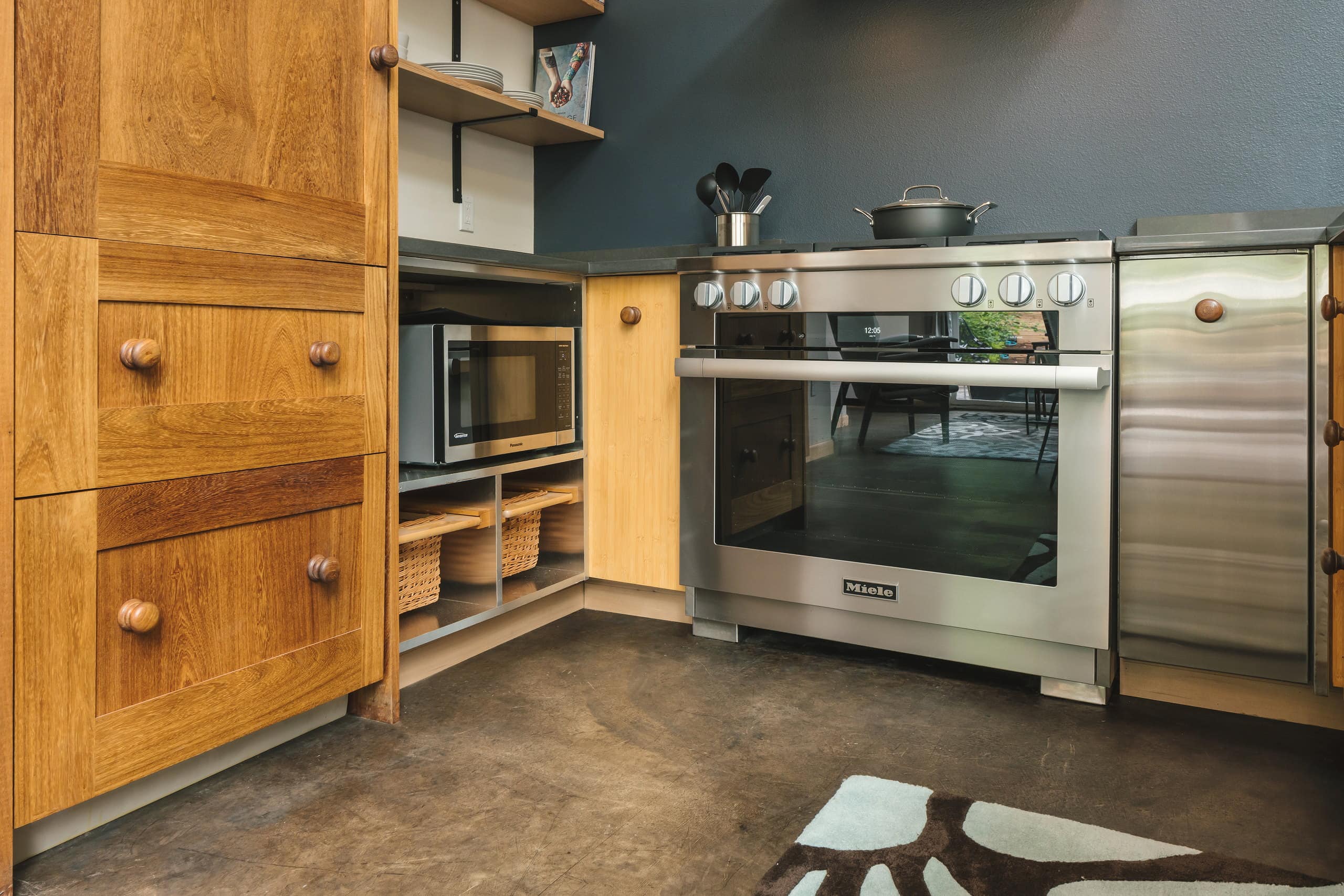 Pantry cabinet and appliance storage beside the range.