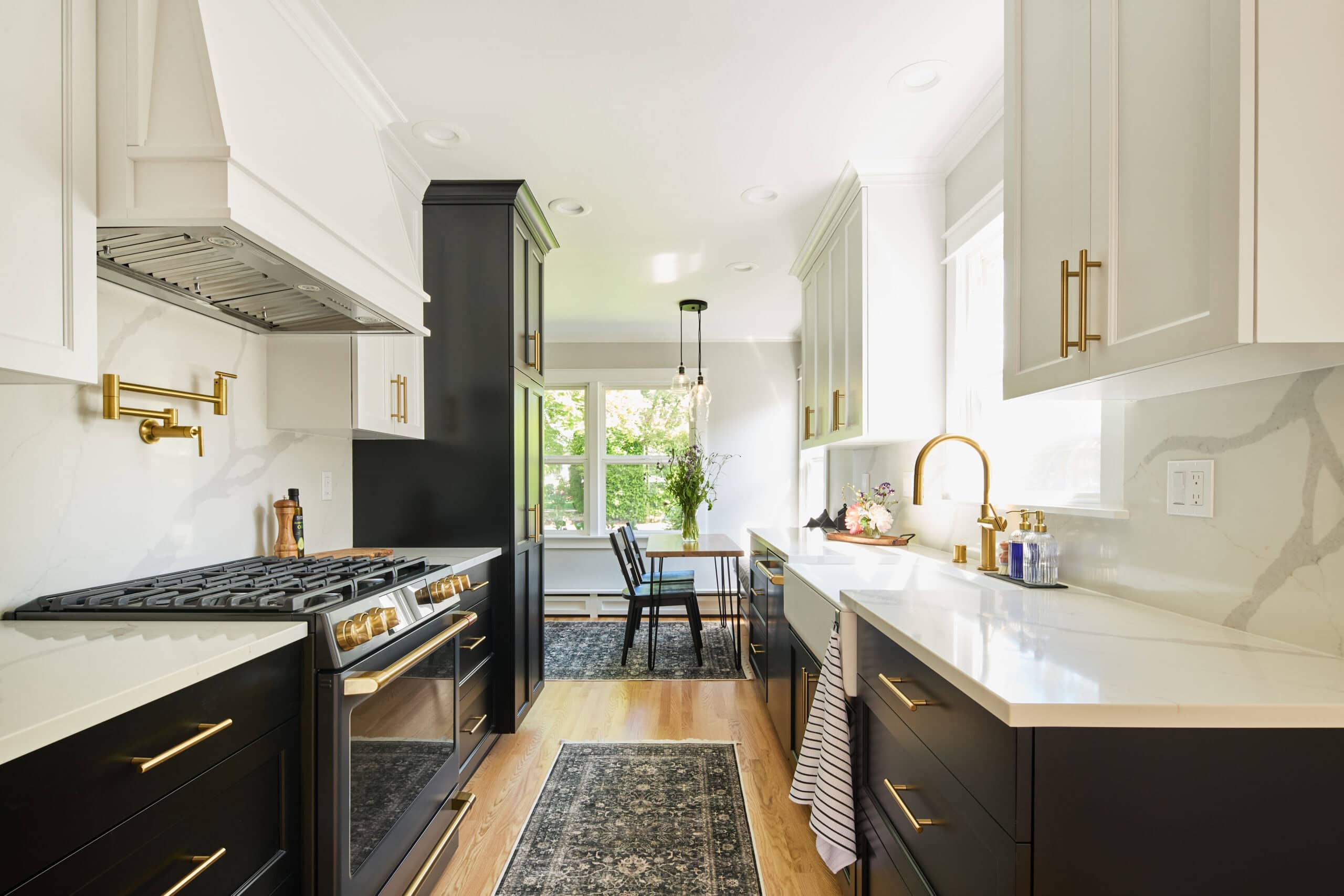 A remodeled kitchen with black and white cabinets
