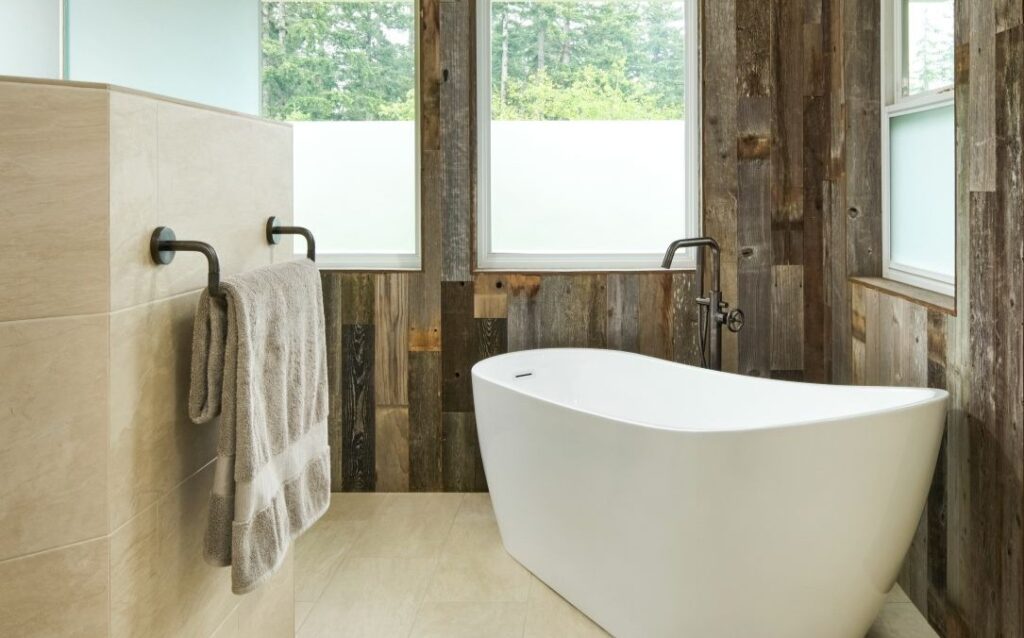 Battle Ground, WA primary bath remodel with freestanding soaking tub, reclaimed wood plank walls, and matte black fixtures