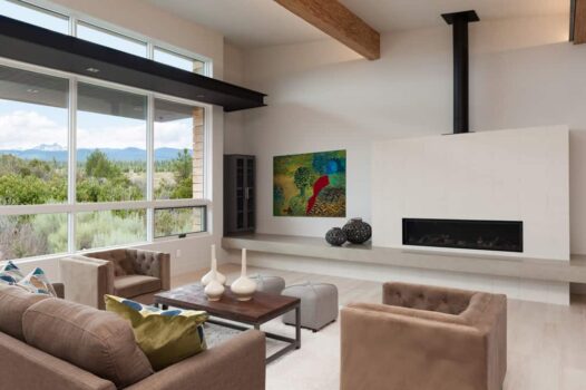 Custom modern living room design by Neil Kelly with gas fireplace and full wall of windows