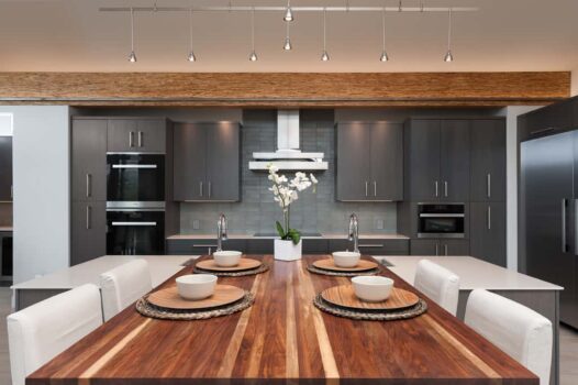 Bend Tetherow Custom Home 006 Modern custom home kitchen with reclaimed beams, walnut butcher block, sintered stone countertop, and recycled glass.