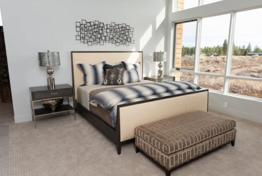 Bend Tetherow Custom Home 014 Modern custom home bedroom with large windows.