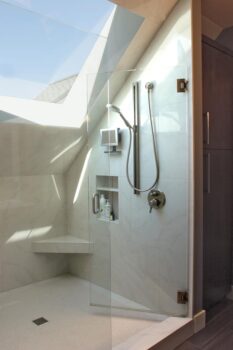 Birdshill Attic Remodel Portland 005 Attic remodel bathroom shower with skylight, frameless shower door, niche shelf, angled bench and handshower showerhead.