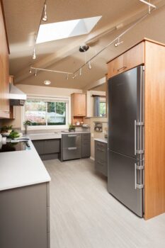 Canby ADA Kitchen Portland 001 Accessible design kitchen with track lighting, wheelchair accessible sink, dishwasher drawers, and induction cooktop.